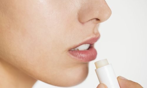 Portrait of white woman doing her daily skincare routine